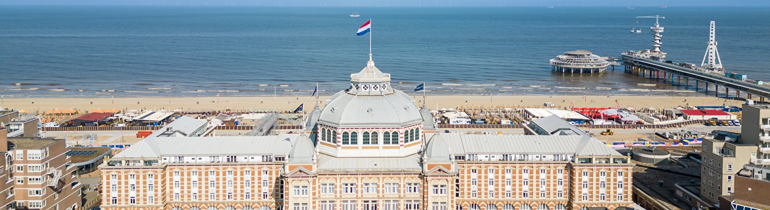 Grand Hotel Amrâth Kurhaus in Scheveningen, on the beach. With Dutch flag on the dome.